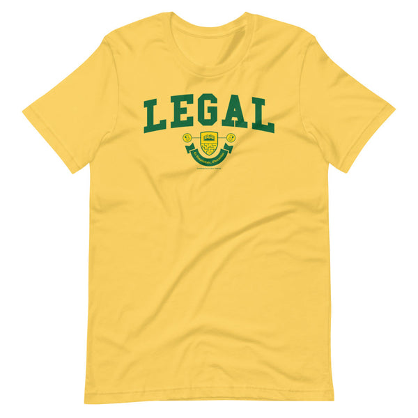 A yellow t-shirt with the Legal Crest on it in green with yellow accents. 
